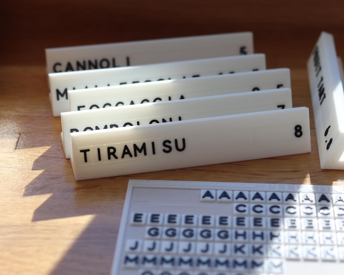 LettrBoard counter signs reading CANNOLI and TIRAMISU with a character sheet