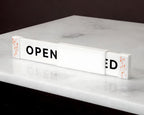 LettrBoard sliding open/closed sign on a marble surface showing OPEN