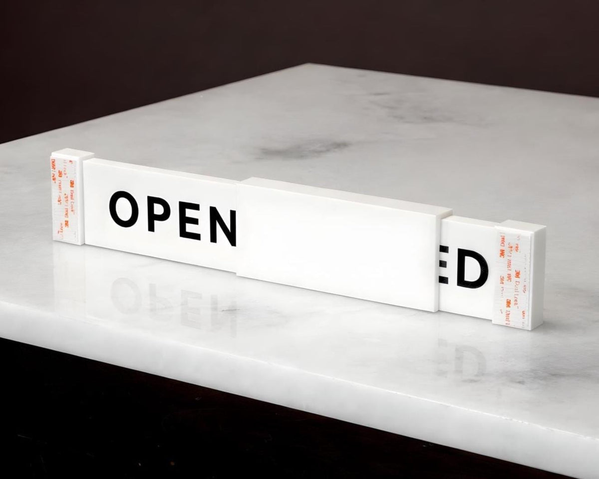 LettrBoard sliding open/closed sign on a marble surface showing OPEN