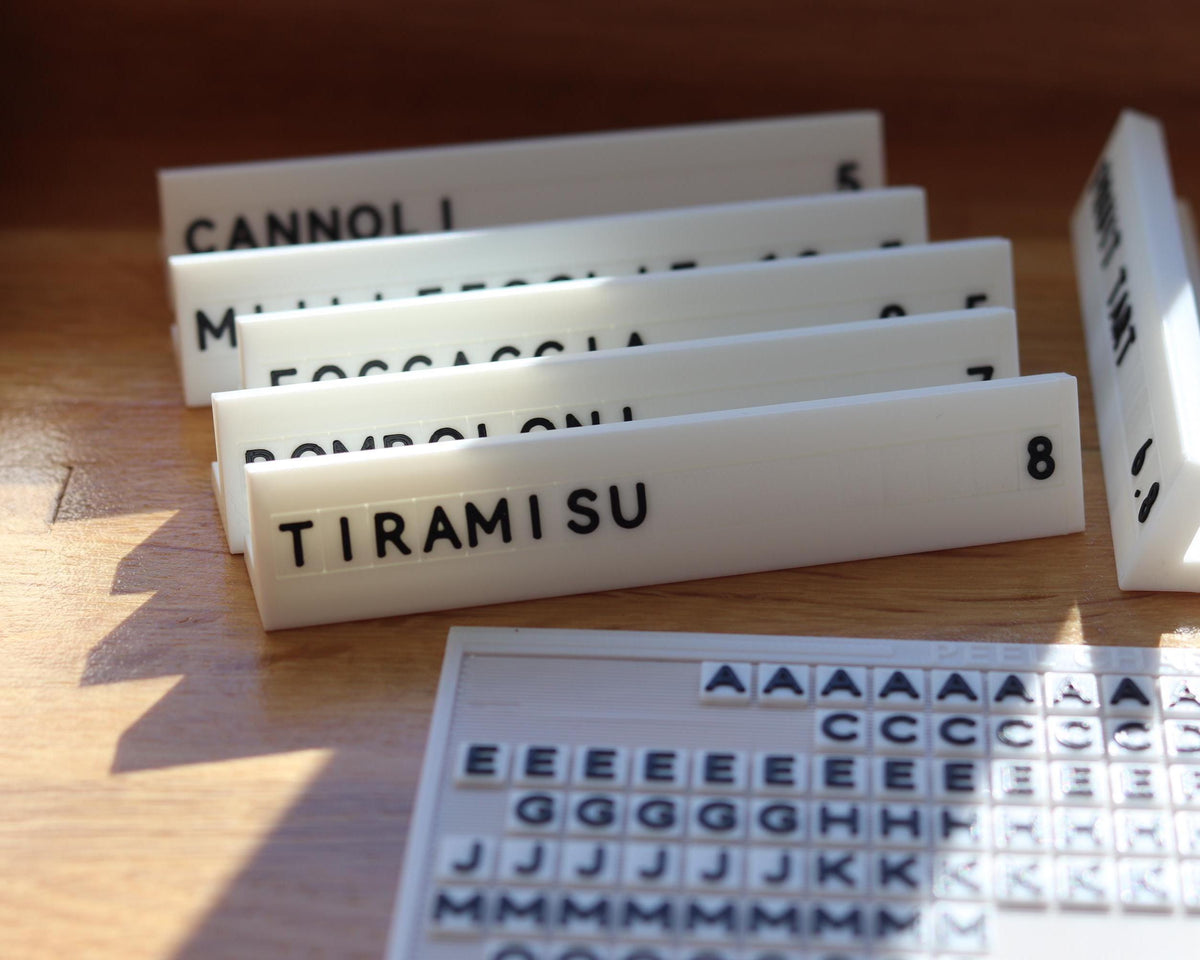 LettrBoard counter signs reading CANNOLI and TIRAMISU with a character sheet