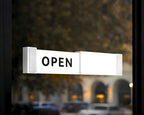 LettrBoard sliding open/closed sign showing OPEN on a glass storefront door