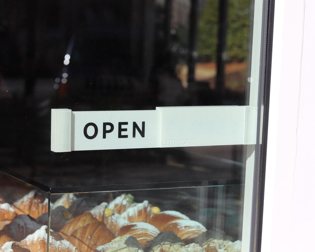 LettrBoard OPEN sign mounted on a glass bakery door