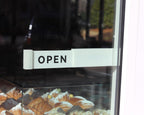LettrBoard OPEN sign mounted on a glass bakery door