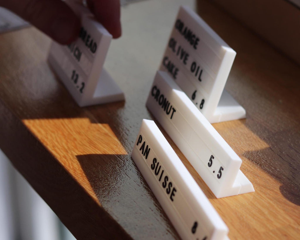 LettrBoard modular counter signs on a wooden shelf edge