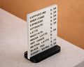 LettrBoard tabletop menu sign showing a coffee menu with prices on a café counter