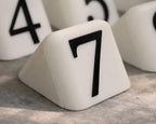 Close-up of LettrBoard table number 7 with raised black numerals