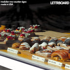 LettrBoard price signs labeling pastries in a bakery display case