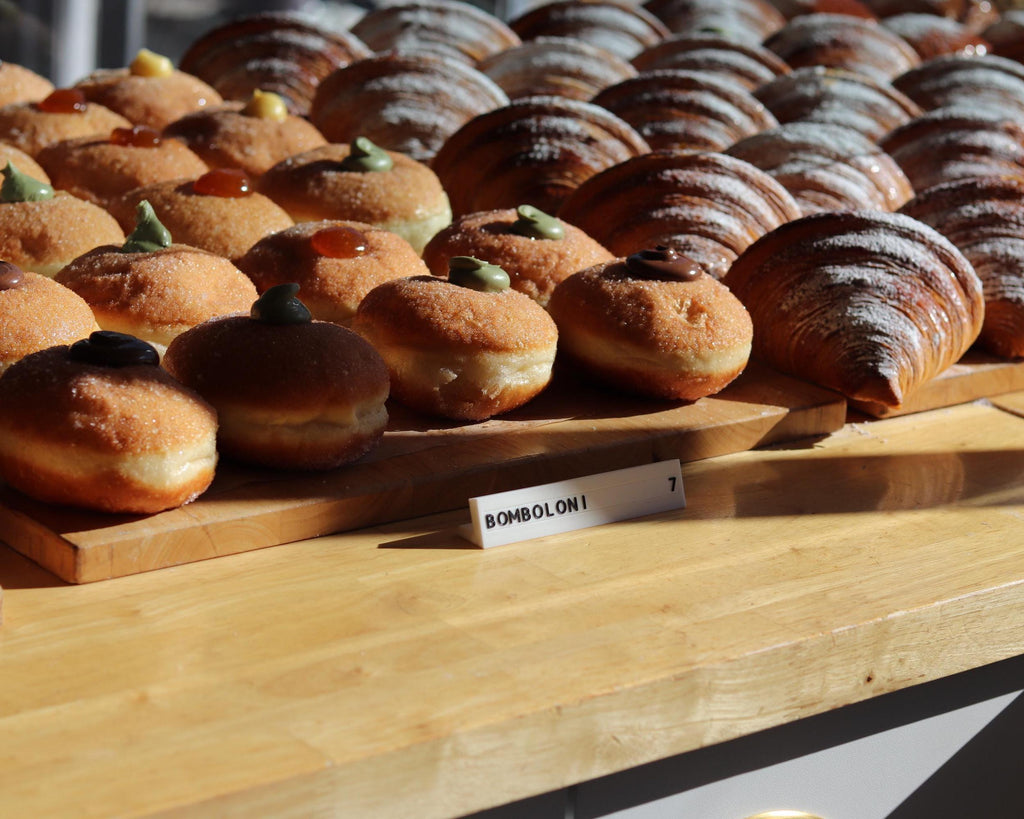 LettrBoard price sign in front of a tray of glazed pastries