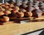 LettrBoard price sign in front of a tray of glazed pastries
