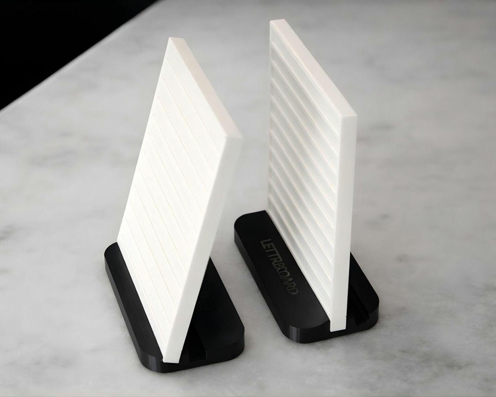 LettrBoard tabletop menu signs standing upright and tilted on black dual-angle bases