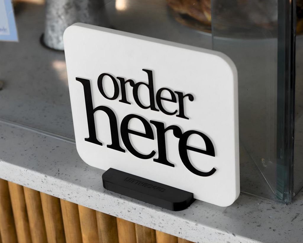 LettrBoard Order Here sign with raised lettering on a dual-slot base