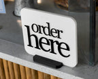 LettrBoard Order Here sign with raised lettering on a dual-slot base