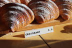 LettrBoard counter sign reading CROISSANT 5.5 in front of croissants